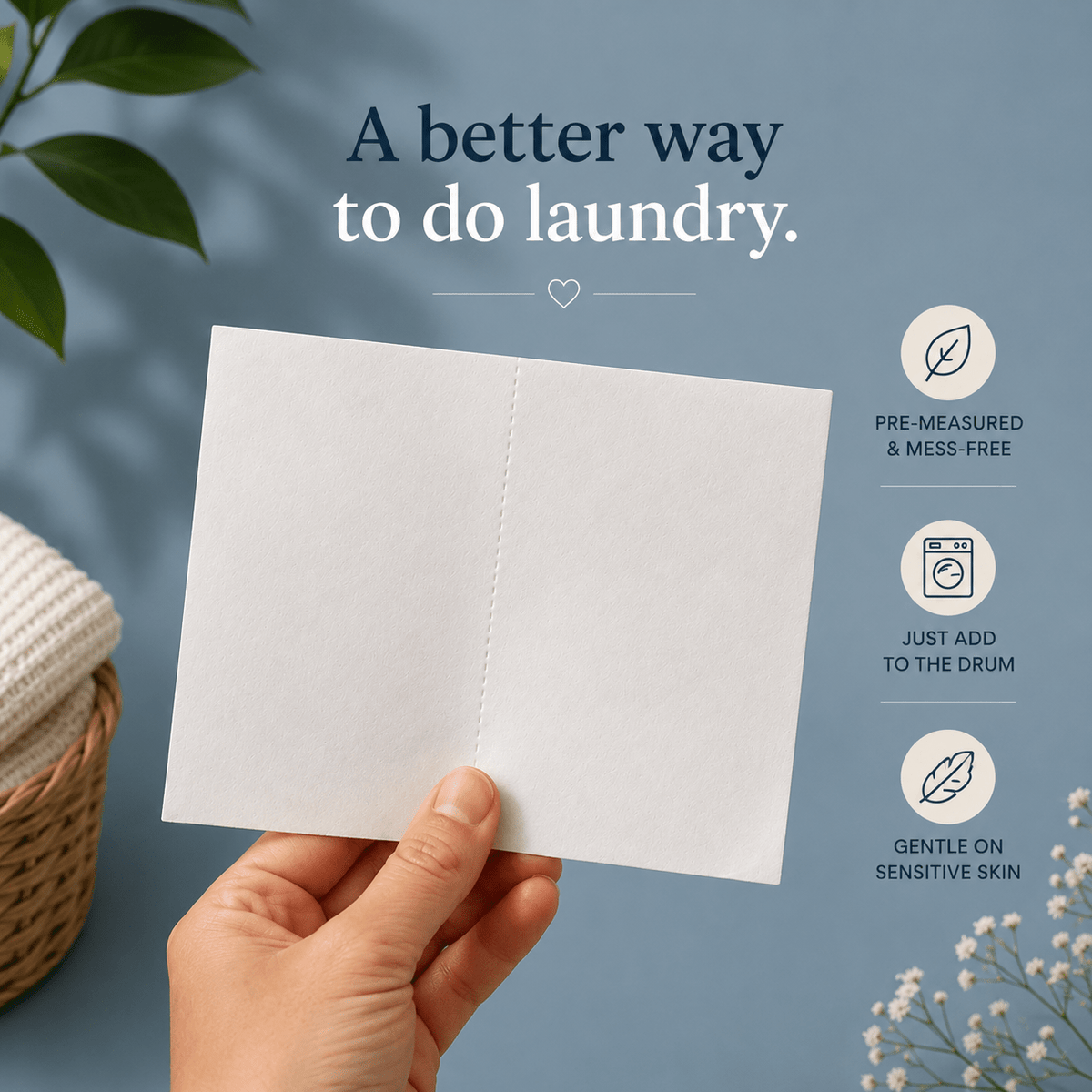 A hand holds a barekin laundry sheet against a soft blue background with text and icons promoting a laundry aid product. The scene includes decorative leaves, a basket, and small white flowers.